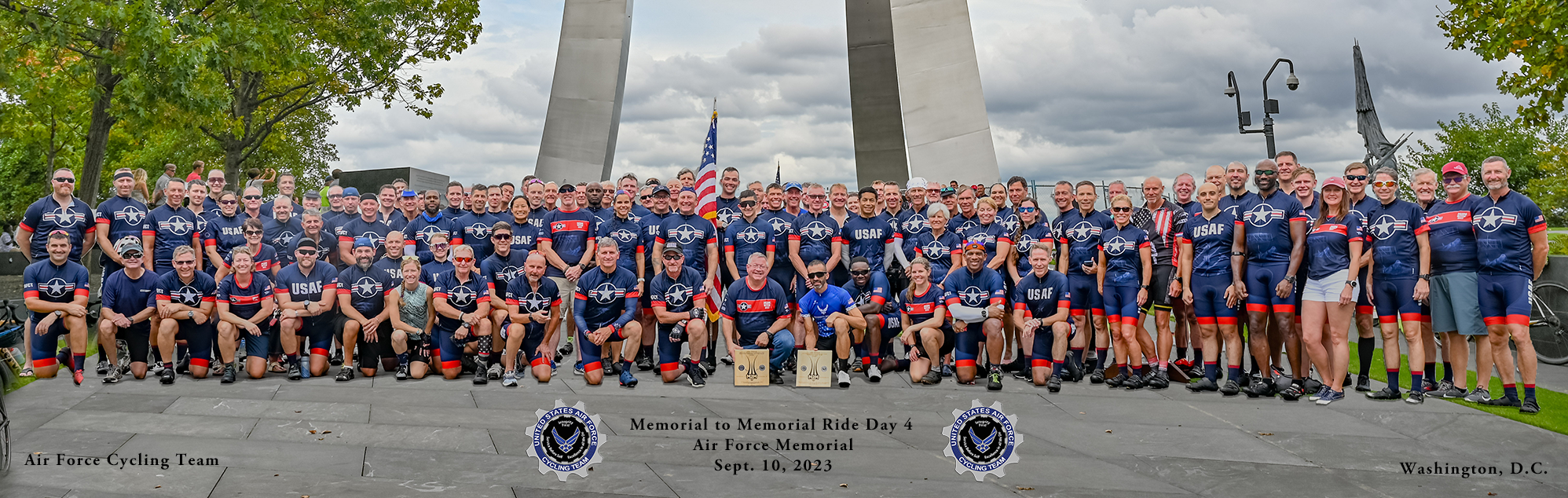 Cyclists posing for a group photo.